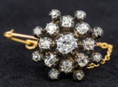 A Victorian unmarked gold diamond set pendant/brooch Of rounded cluster form. 2 cm diameter.