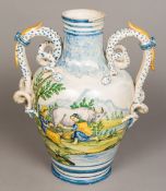 An Italian majolica twin handled vase The body decorated with milkmaids in a mountainous landscape