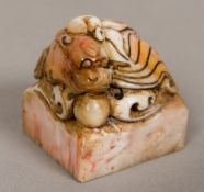 A Chinese soapstone seal Of square section form, carved with a dog-of-fo,