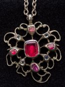 An antique, possibly 18th century, garnet and paste set unmarked silver pendant Of pierced form,