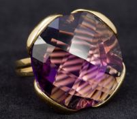 An 18 ct gold amethyst ring Set with a large facet cut amethyst. 2.75 cm high.