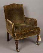 A Victorian mahogany framed child's upholstered armchair The shaped back above the low arms and