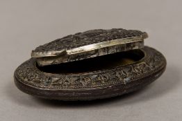 A 19th century carved coquilla nut snuff box Of flattened oval form,