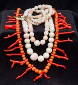 A red coral bead and stick necklace Together with two angel skin coral bead necklaces.