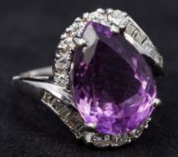 An 18 ct white gold amethyst and diamond ring The central drop shaped facet cut amethyst bordered