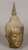 An Eastern gilt bronze Buddha's head Typically worked. 36 cm high.