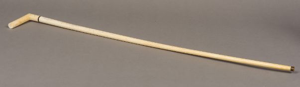A 19th century whale bone and marine ivory walking stick The marine ivory handle above an ebony