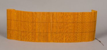A Chinese bamboo slip book Each slip incised with calligraphic text. 117 cm long.