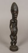 An African tribal carved wooden figure Formed as a bearded male with scarification marks,