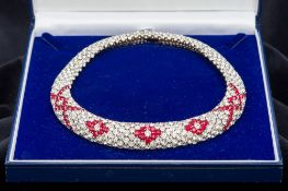 An Art Deco white and red cut paste set white metal (tests as silver) necklace 15 cm diameter.