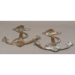 A pair of cast bronze anchors With engraved details to one side. 48.5 cm high.