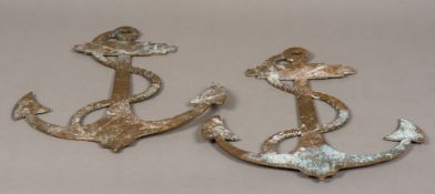 A pair of cast bronze anchors With engraved details to one side. 48.5 cm high.