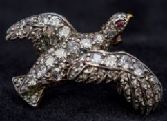 An Edwardian unmarked gold, diamond and ruby set brooch Modelled as a game bird. 2.25 cm long.