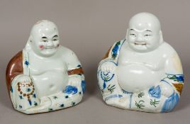Two Chinese porcelain figures of Buddha Each typically modelled with painted decoration.
