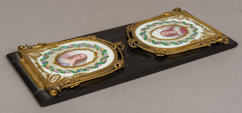 A 19th century ormolu and Sevres style painted porcelain mounted book slide Each end panel painted
