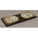 A 19th century ormolu and Sevres style painted porcelain mounted book slide Each end panel painted