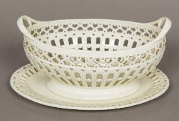 A late 18th/early 19th century Staffordshire creamware twin handled basket and stand,