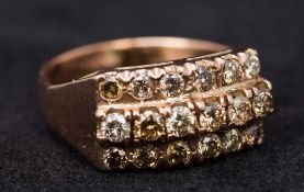 An antique unmarked gold diamond set ring The small stones set in three rows. 1.5 cm wide.