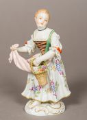 A Meissen porcelain figurine Modelled as a flower girl, the underside with blue crossed swords mark.