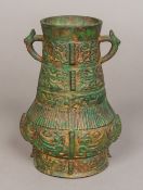 A Chinese bronze archaistic twin handled vase Typically worked with bands of decoration and flanges,