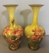 A pair of Doulton Lambeth faience vases Decorated with floral sprays by Kate Rogers, printed,