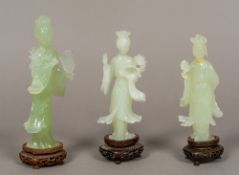 Three Chinese carved jade type figures of Guanyin Typically modelled,