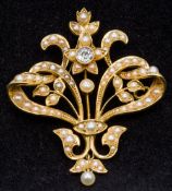 A Victorian 15 ct gold, diamond and seed pearl set pendant/brooch Of pierced scrolling floral form,