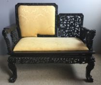 A 19th century Chinese carved hardwood settee Of small proportions,