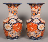 A pair of 19th century Japanese Imari vases Decorated with hexagonal panels worked with floral