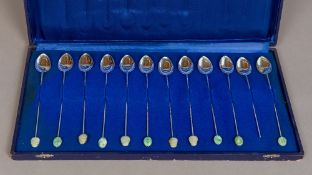 A set of twelve Chinese silver spoons Each with faux bamboo stem and carved jade terminal,