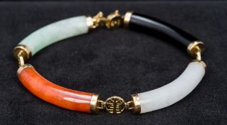 A 14K gold set jade bracelet Set with four different coloured tubular jade sections. 18 cm long.