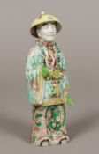 An 18th century Chinese porcelain figure Formed as man wearing ornate robes and a hat. 16 cm high.