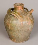 A Chinese pottery wine pot The ribbed baluster body with three handles and a spout. 40 cm high.