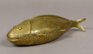A 19th century Indian brass box Formed as a fish with removable lid. 29 cm long.
