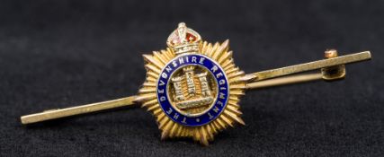 A 9 ct gold and enamel Regimental bar brooch Centred with the crest of the Devonshire Regiment.