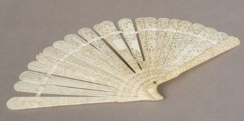 A 19th century Chinese carved ivory fan The end guards and blades worked with figures in a