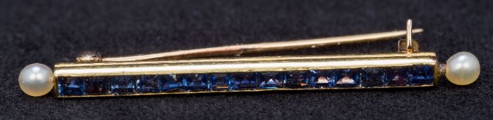 An Art Deco unmarked gold sapphire and seed pearl bar brooch Set with calibre cut sapphires with