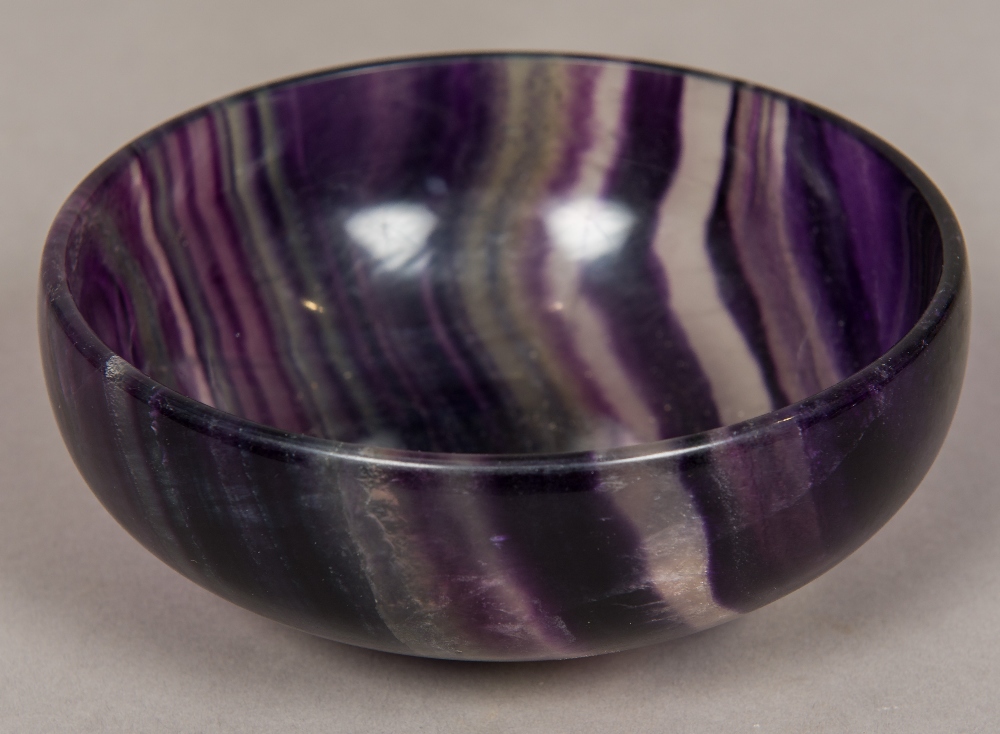 A Florspar type mineral bowl Of simple dished form, with a low foot. 15.5 cm diameter.