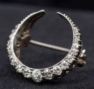 A Victorian unmarked diamond set brooch Of crescent moon form. 2.25 cm wide.