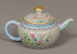 A Chinese porcelain teapot and cover Extensively worked with floral sprays on a diaper ground,