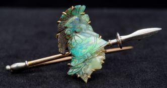 An unmarked high carat gold and carved opal bar brooch Formed as the bust of a classical warrior