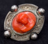 An antique silver carved coral cameo brooch Centrally set with a bust,