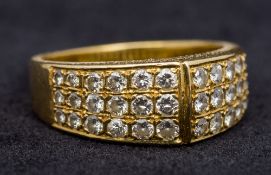 An 18 ct gold diamond set ring With three rows of graduated stones.