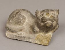 A Chinese carved stone figure of a cat Modelled recumbent looking aloft. 20 cm long.