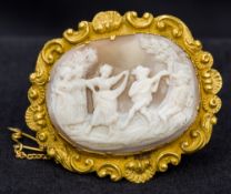 A 19th century gilt metal framed carved cameo brooch Depicting a festive scene. 5 cm wide.