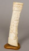 A World War I prisoner-of-war bone carving Carved to one side with a bird on a flowering stem,