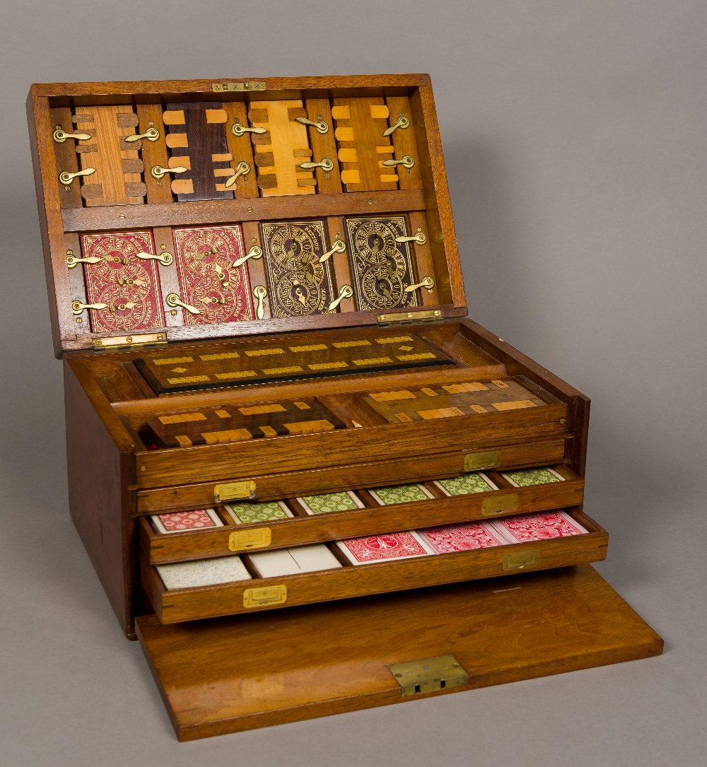 A Victorian walnut cased games compendium The hinged rectangular lid with vacant brass cartouche,