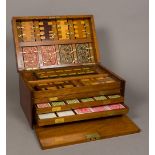 A Victorian walnut cased games compendium The hinged rectangular lid with vacant brass cartouche,
