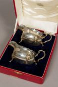 A cased pair of Edward VIII silver sauceboats, each hallmarked Birmingham 1936,