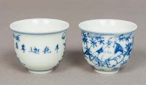 A pair of Chinese blue and white porcelain wine cups Each decorated with a deity opposing